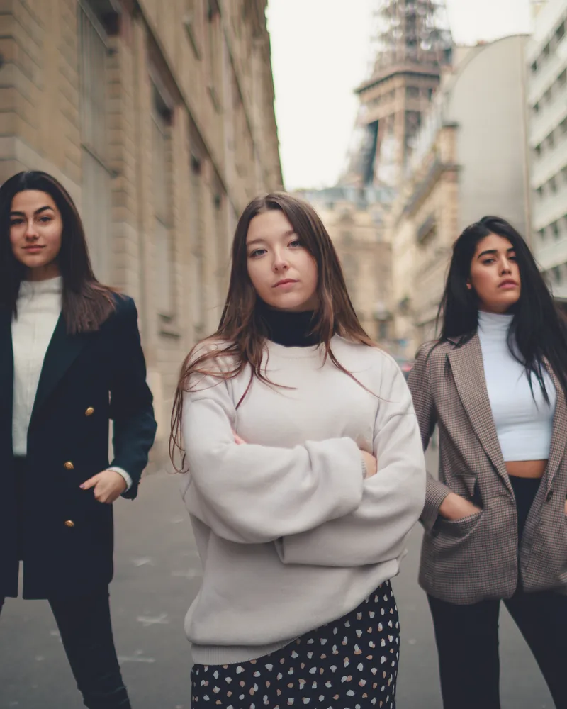 Three women in coats on a Paris street